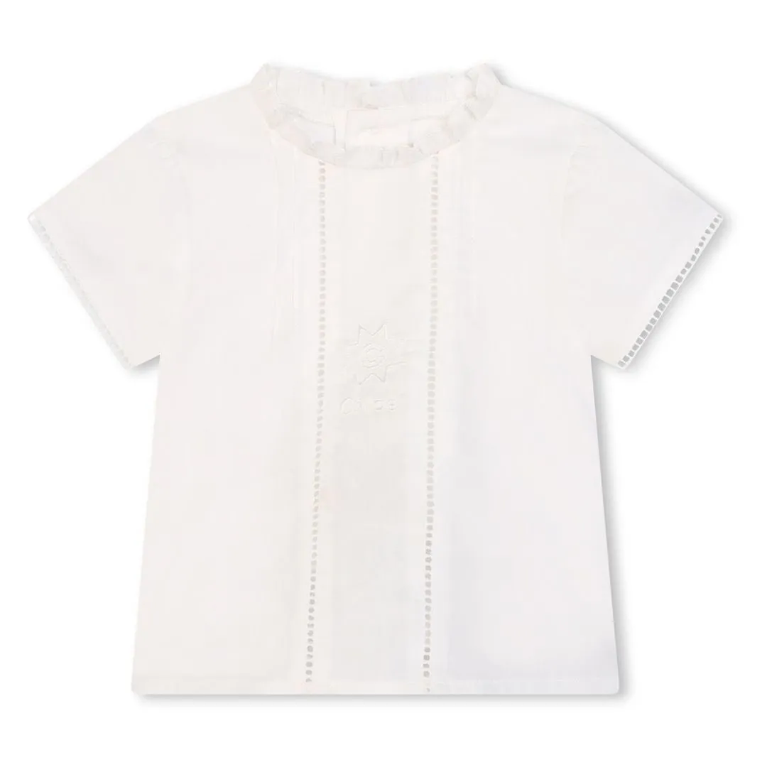 White Ruffle Blouse and Blue Shorts